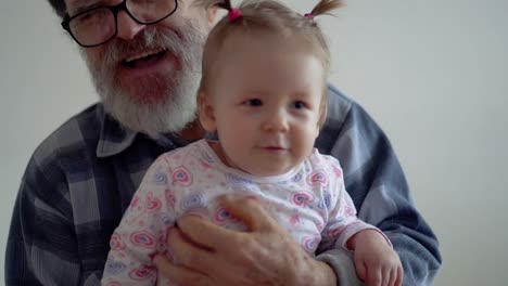 grandfather with a beard wearing glasses playing