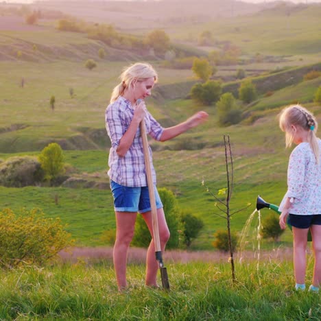 A-Young-Woman-With-Her-Daughter-6-Years-Old-Plant-A-Tree