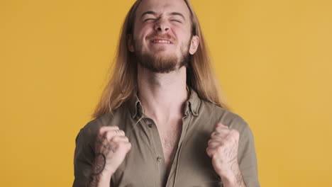 caucasian young man celebrating victory in front of the camera.