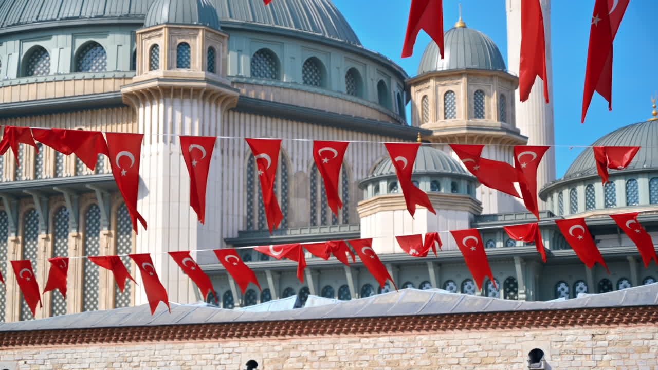 View of the Taksim Mosque in Istanbul, Turkey. Multiple national flags on the foreground