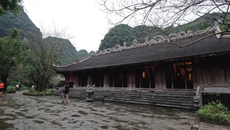 people walking near a traditional vietnamese building