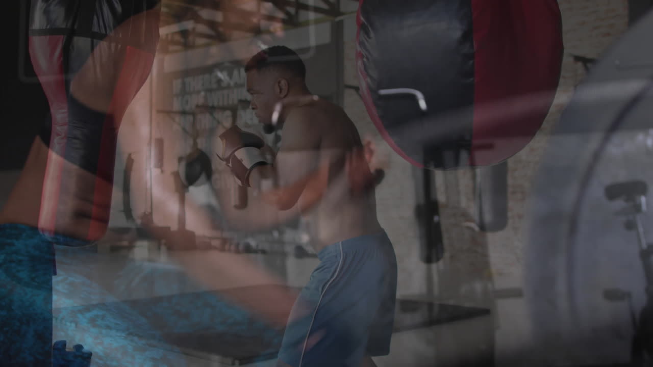 Practicing punches in gym, boxer with animation of training equipment