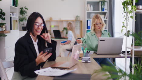 Female-Office-Worker-on-Phone-with-Client