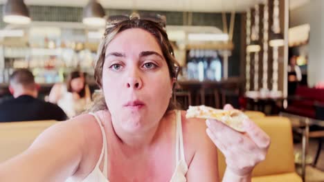 woman savoring a slice of pizza during athens trip