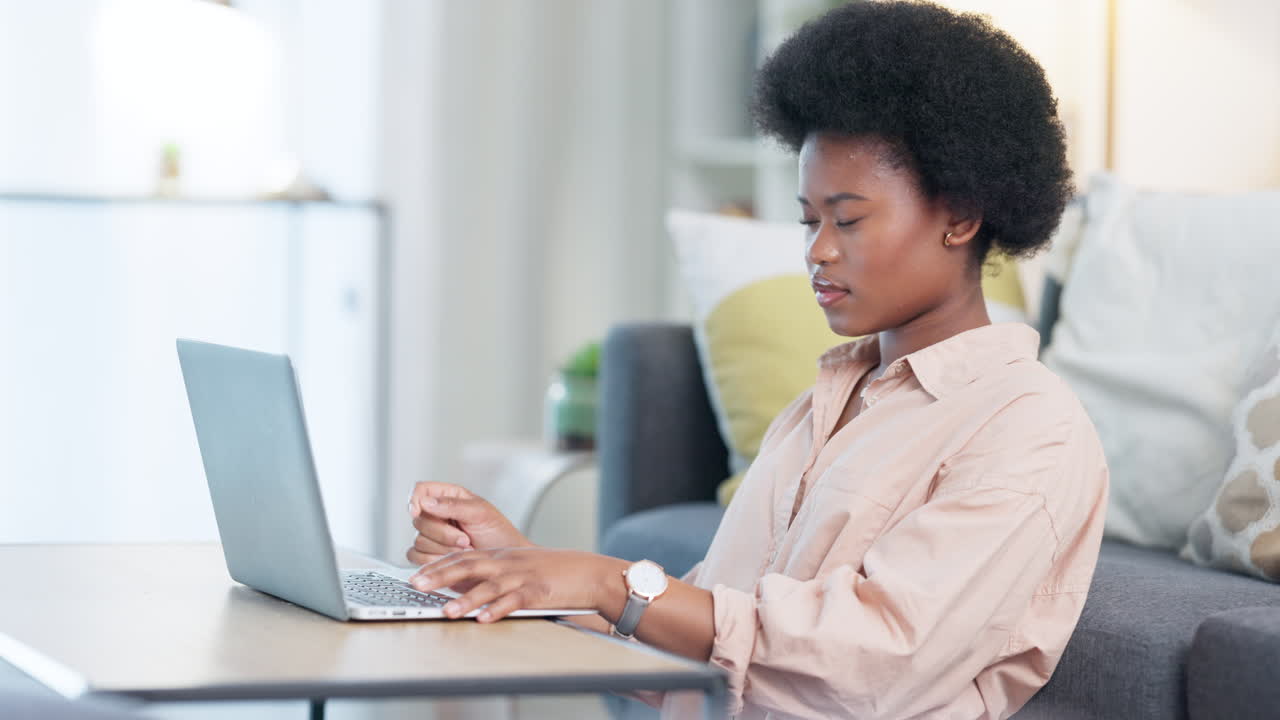 Focused African American female freelancer sits