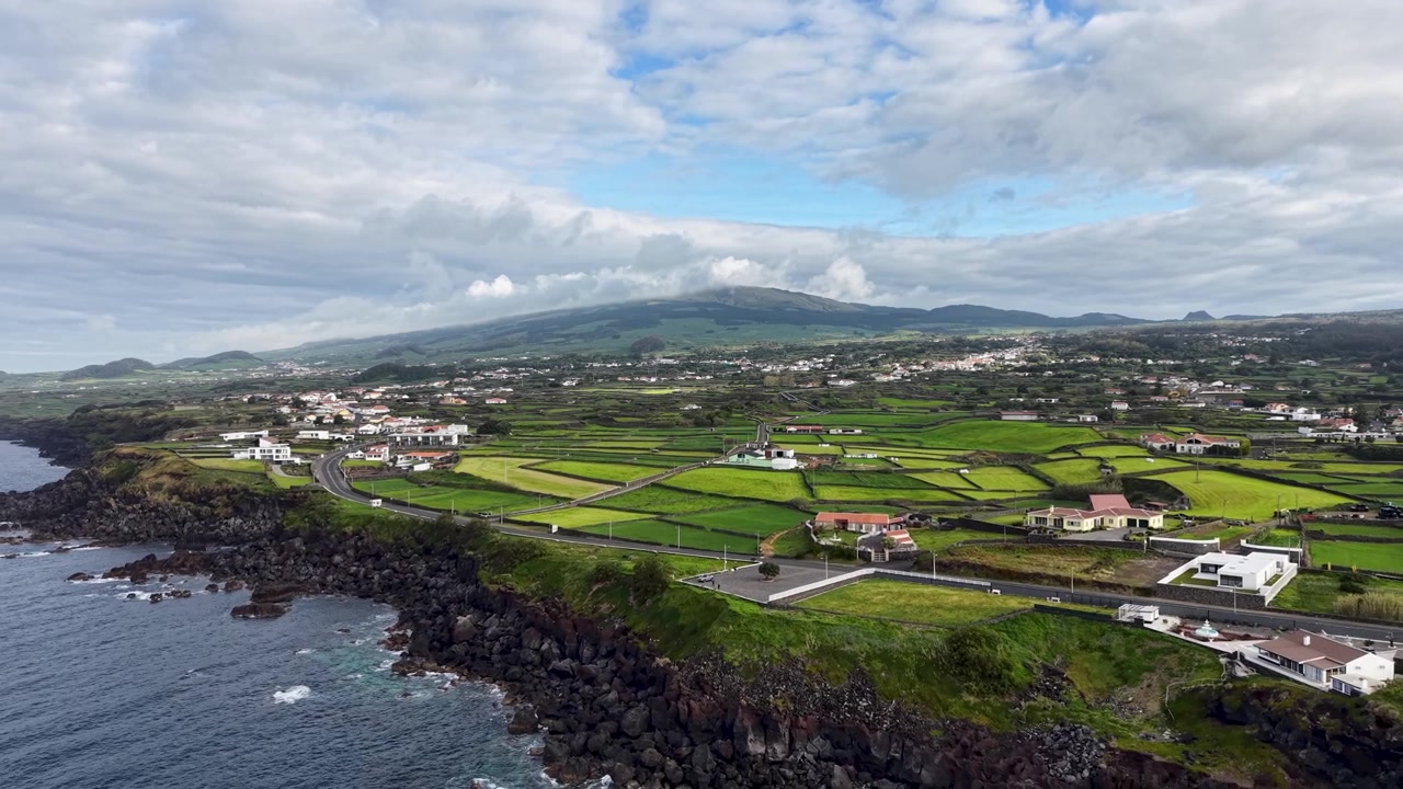 Ampio panorama ripreso da drone di campi agricoli a mosaico e campagna rurale con montagne sull'isola di Terceira nelle Azzorre, Portogallo.