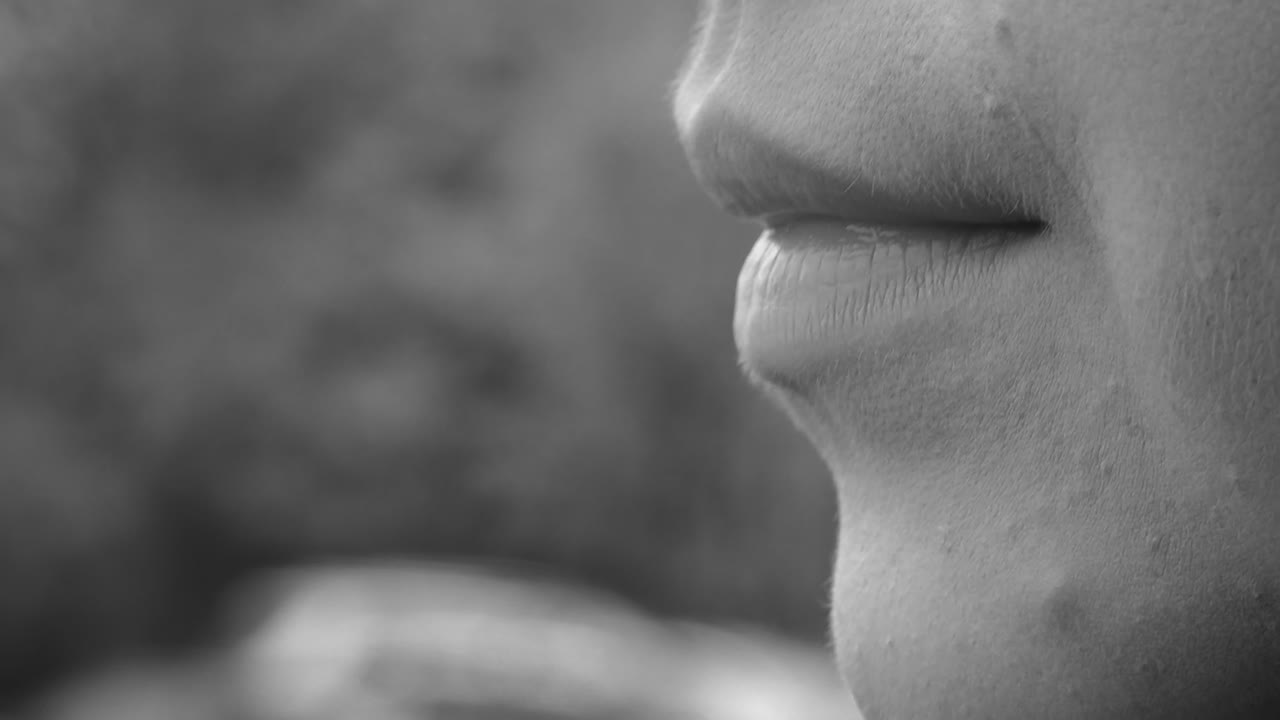 A woman smokes an electronic cigarette