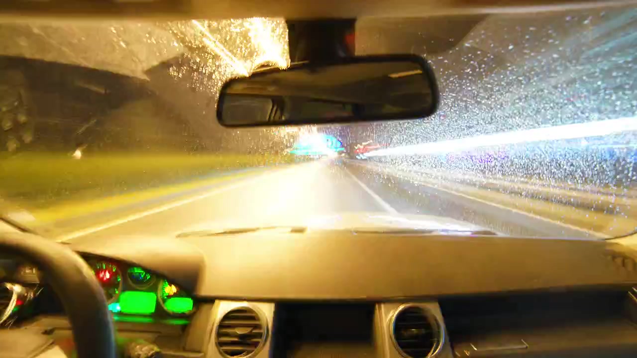 Driving Through a Tunnel at Night with Rain on Windshield
