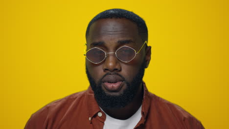 Closeup-positive-african-american-man-waving-head-yes-on-yellow-background.