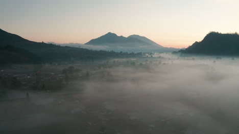 early morning low lying fog blankets a farmland valley