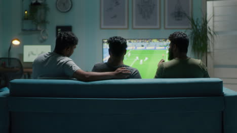 friends watching soccer game at home