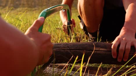 Two-People-Saws-Together,-Teamwork-And-Friendship-Concept,-Close-Up