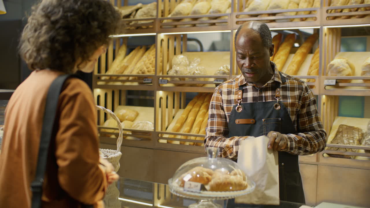 Customer purchasing bread at a bakery