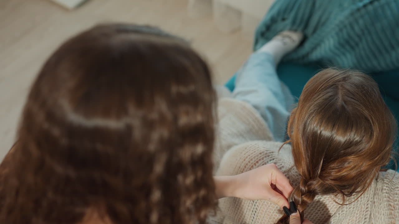 Tender Moments Through Intimate Family Bonding, Warm Afternoon With Family Members Engaged In Gentle Activities, Peaceful Scene Of Mother Creating Braid In Comfortable Family Surroundings