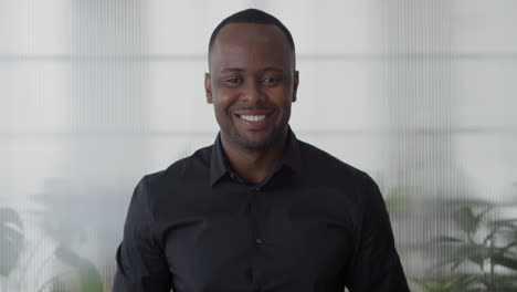 portrait confident young african american entrepreneur smiling enjoying professional lifestyle success black businessman in office slow motion career ambition