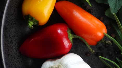 making a vibrant cajun spice blend, mixing red paprika, cayenne pepper, oregano, thyme, white garlic onion powder and black pepper in a bowl, creating a striking contrast against a black background.