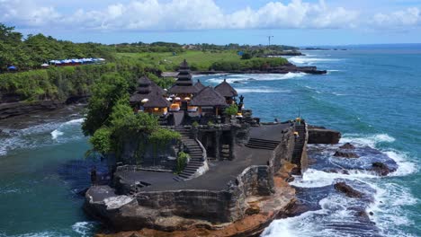 aerial view of pilgrimage temple of pura tanah lot in bali, indonesia - drone shot