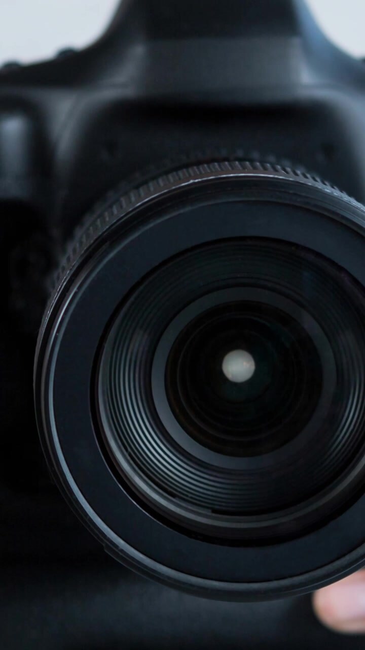 Animation of caucasian woman holding camera over white background
