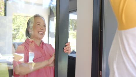 helping senior asian woman with physical therapy, caregiver assisting with arm exercises