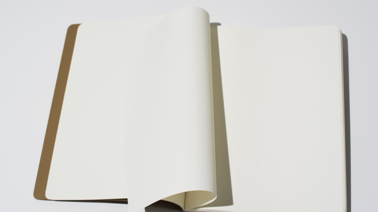 Video of book with white blank pages and copy space on white background