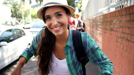 attractive girls is posing with her bike in the street