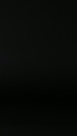 a tennis ball moves across a dark background