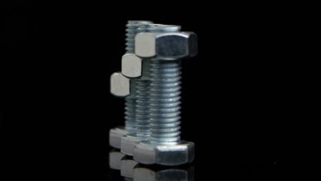 nuts and bolts on a reflective surface