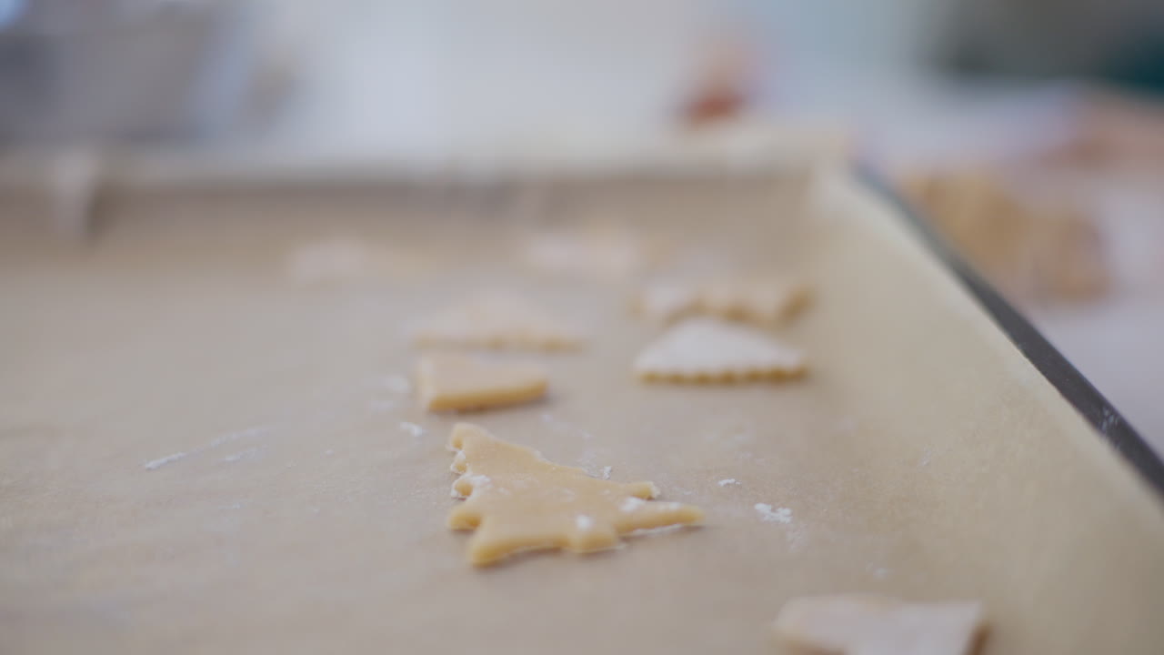 Boy Arranges Cut Out Cookies On Baking Tray
