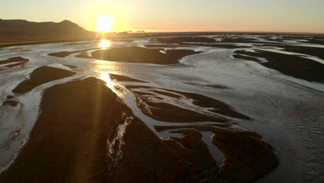 Low-aerial-shot-over-Icelands-winding-braided-river