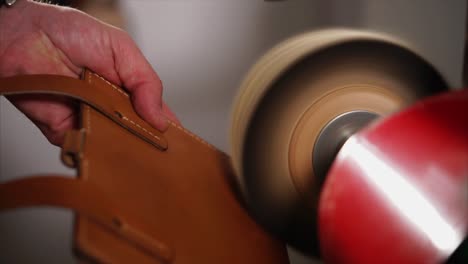 polishing leather wallet with a machine