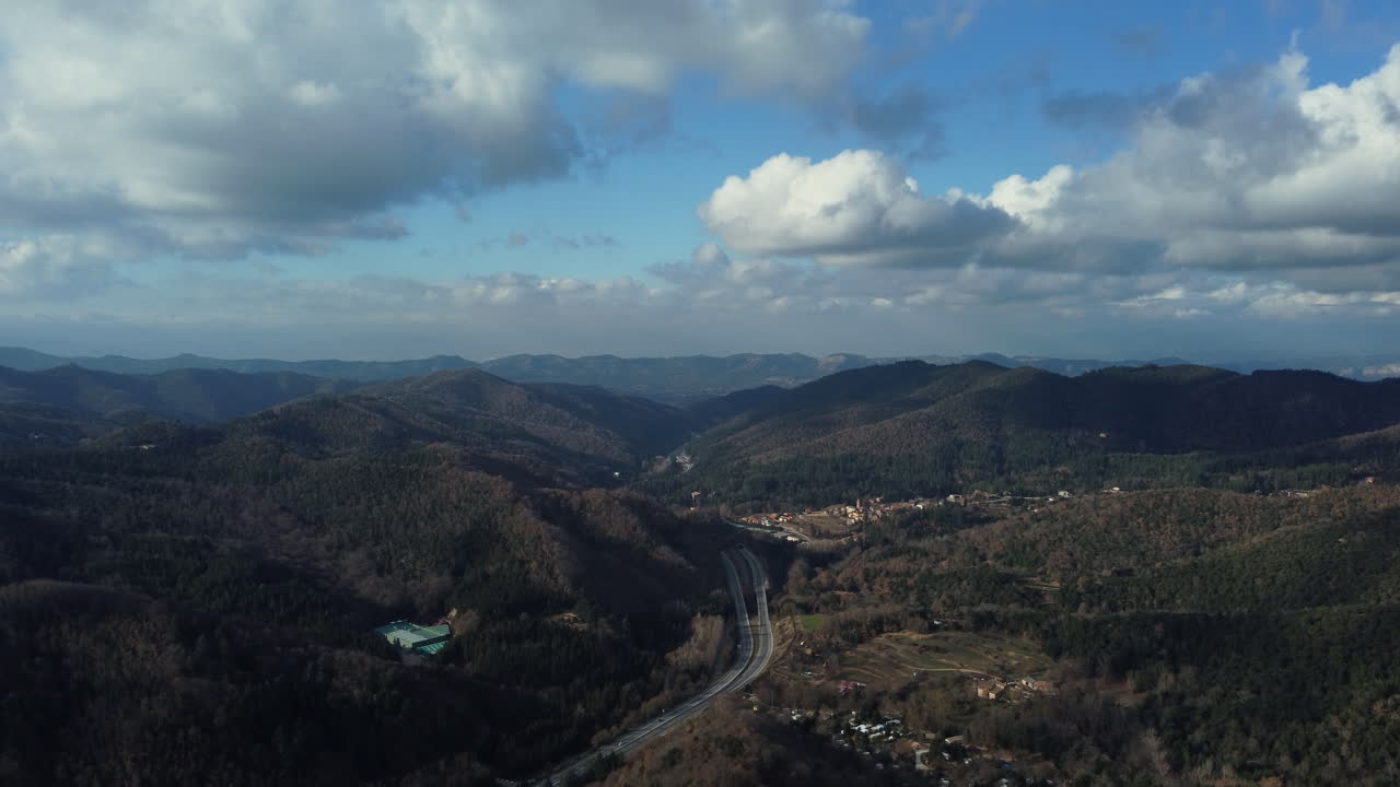 Aerial view of a mountain valley with a road