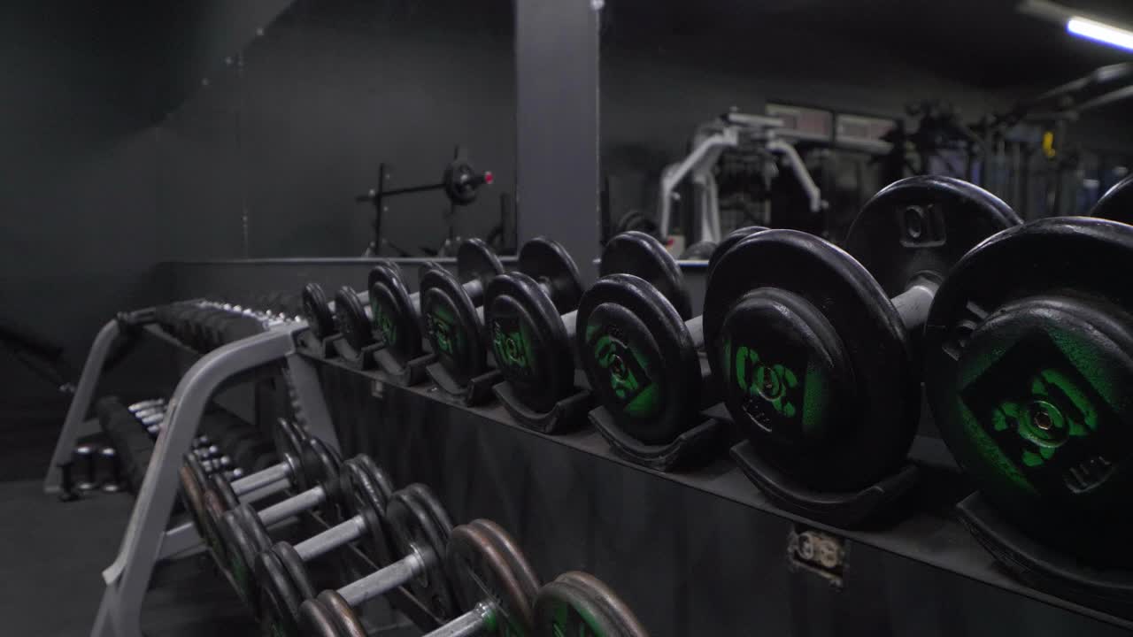 Wide angle gym equipment row of dumbbells inside gym