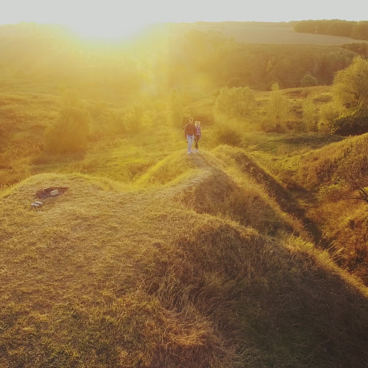 Young Couple Walking Toward Sunset