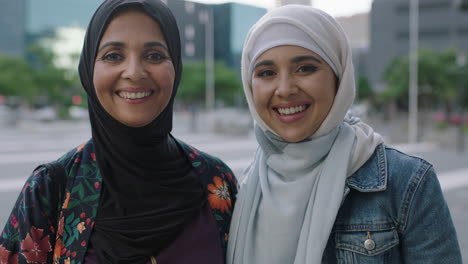 beautiful-portrait-of-muslim-mother-and-daughter-posing-smiling-happy-at-camera-wearing-traditional-hajib-headscarf-in-urban-city