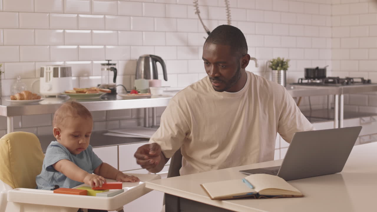 Single Father Working while Babysitting