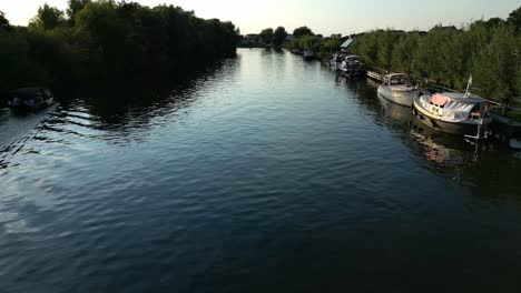 Aerial-Over-Linge-River-With-Ripples-Seen-On-Surface-From-Passing-Boat