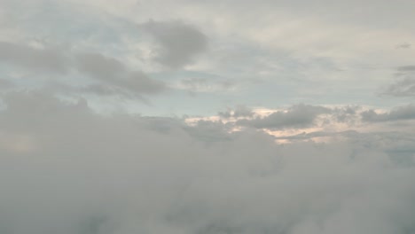 drone aerial rising shot flying over clouds in a beautiful misty cloudy day