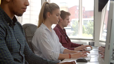 Line Of College Students Using Computers In Study Room