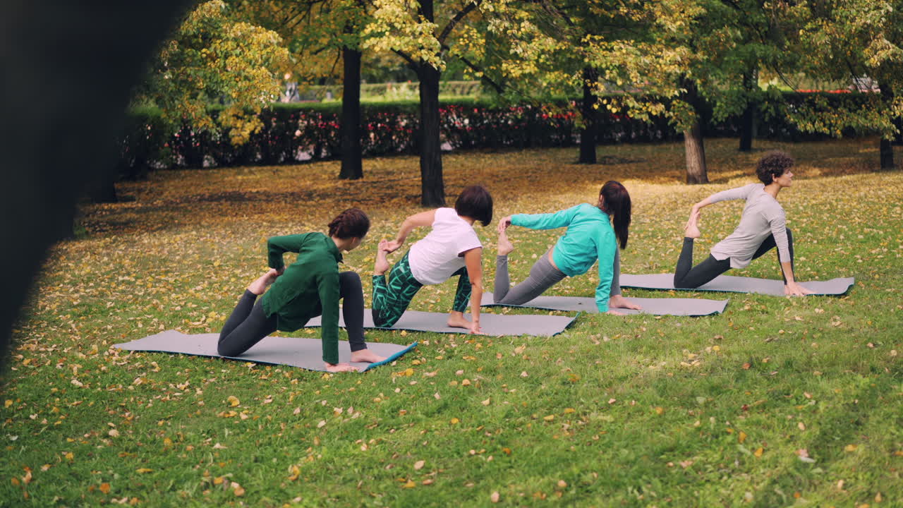 Women Practicing Yoga in an Autumn Park
