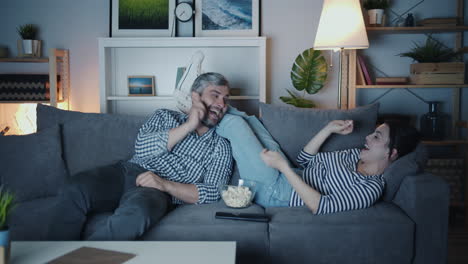 couple relaxing and watching movie at home