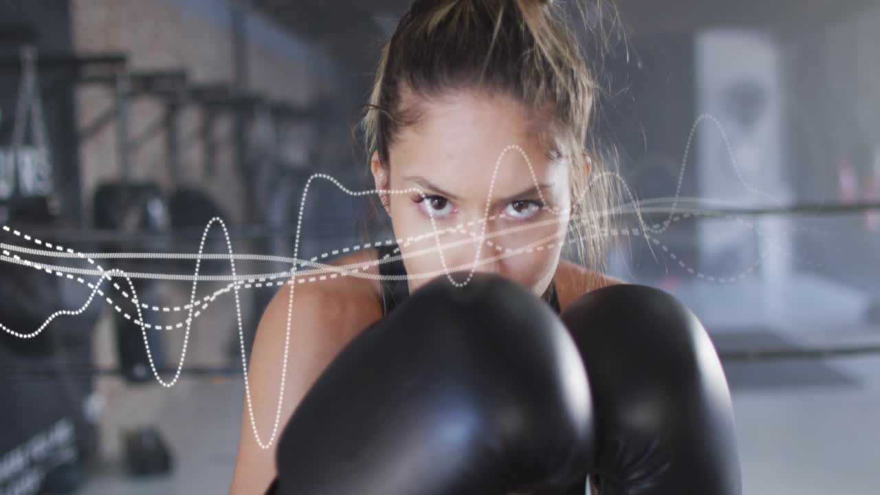 Staring at camera, boxer keeping guard and jabbing for training, waveform tracking face and gloves