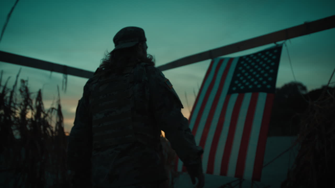 Soldier Walks At Night Near The Ocean And Takes Down The American Flag In Hut