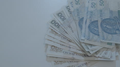 Overhead-Close-Up-View-Of-Various-Polish-Bank-Notes-Fanned-On-Table