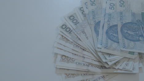 overhead close up view of various polish bank notes fanned on table