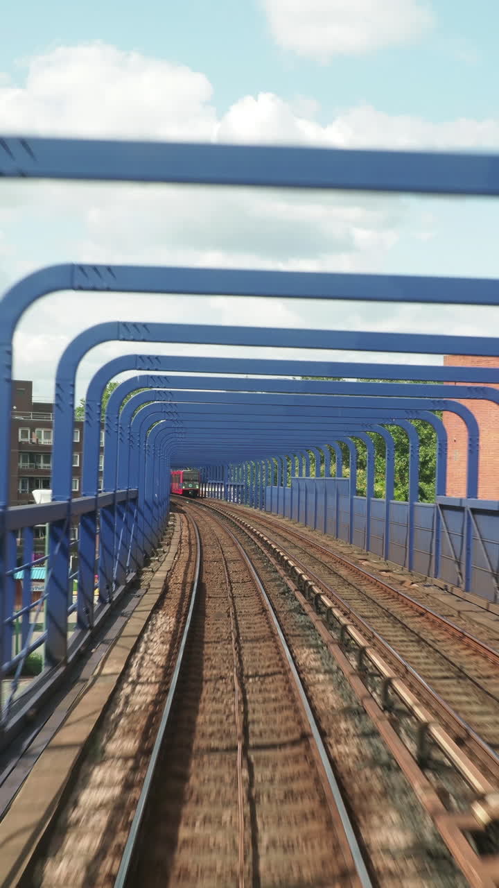 canary wharf in london, POV shot from the moving docklands light railway in vertical