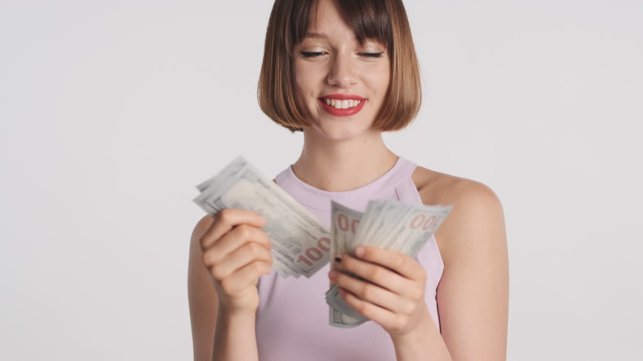 Smiling wealthy girl counting banknotes