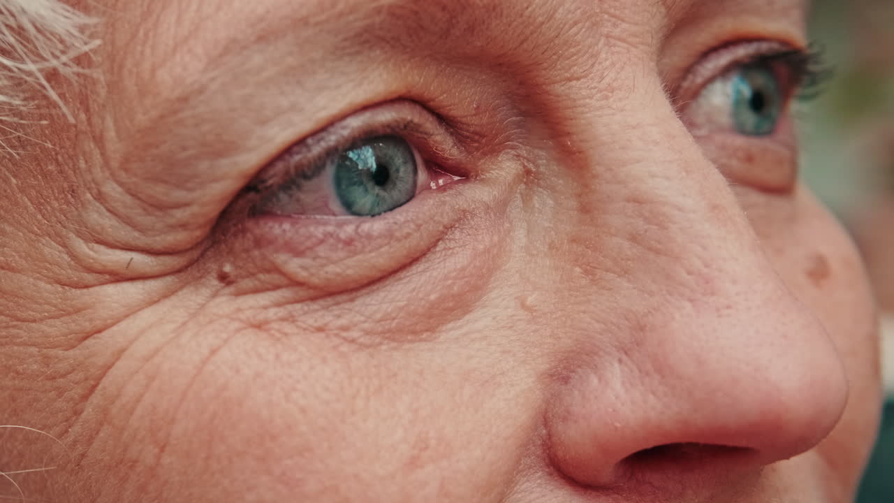 Detailed View of an Elderly Person's Blue Eye and Wrinkles