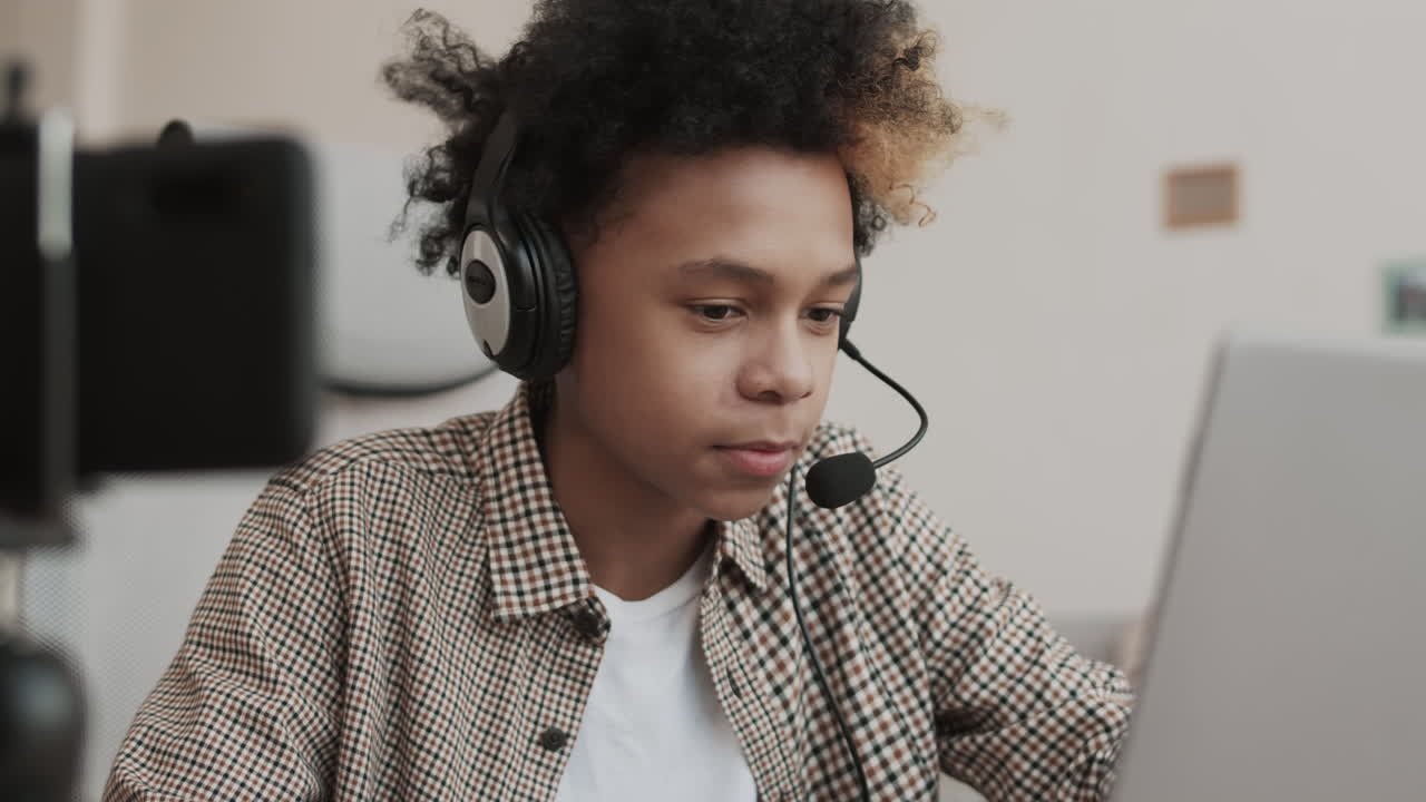 Teenage Gamer Communicating via Headset