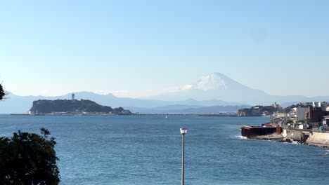 long shot over enoshima with ocean and snow capped mt. fuji in distance