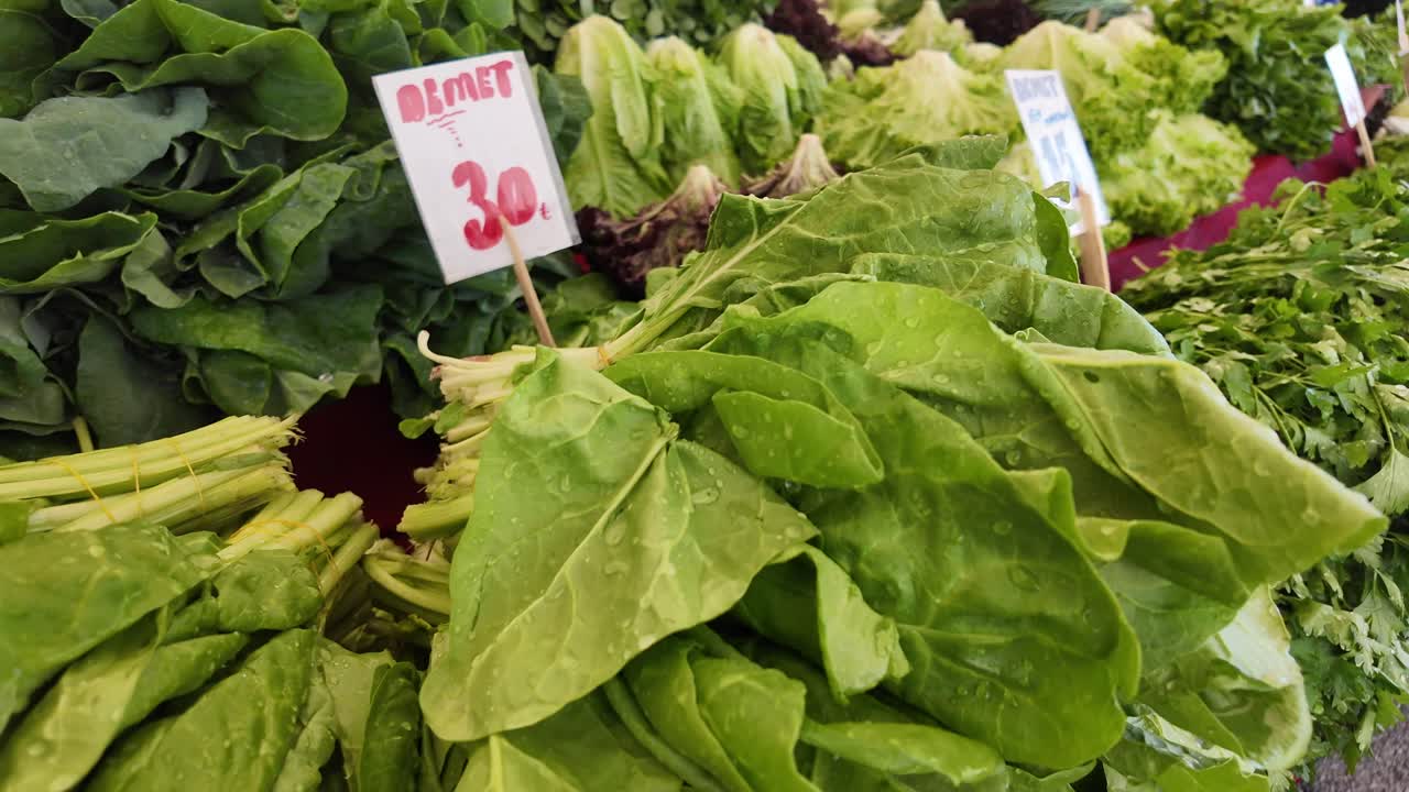 Bundles of Fresh Green Leafy Vegetables at a Market Stall